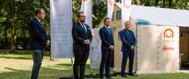Ministrowie na tle domu modułowego.