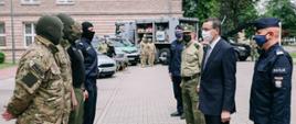 Premier rozmawia z pracownikami służb. 