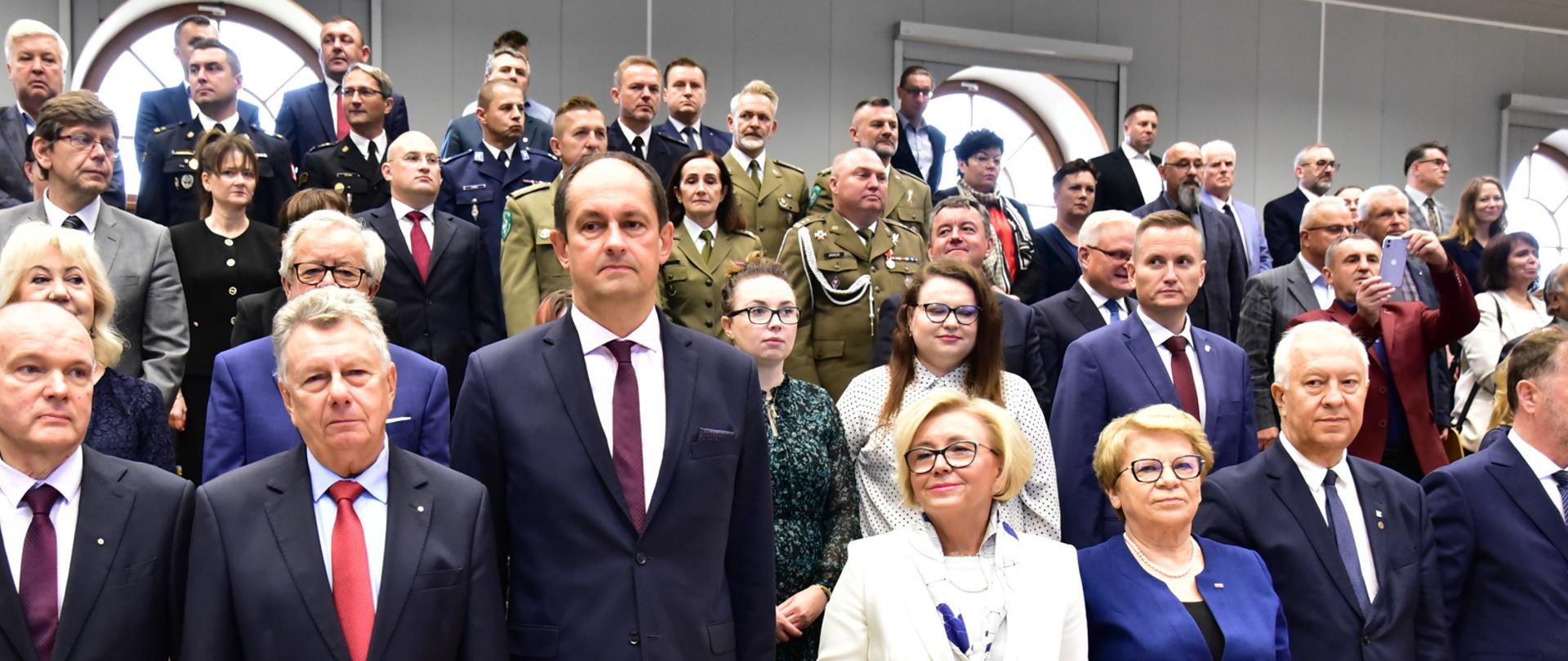 Wiceminister stoi w towarzystwie pozostałych uczestników inauguracji