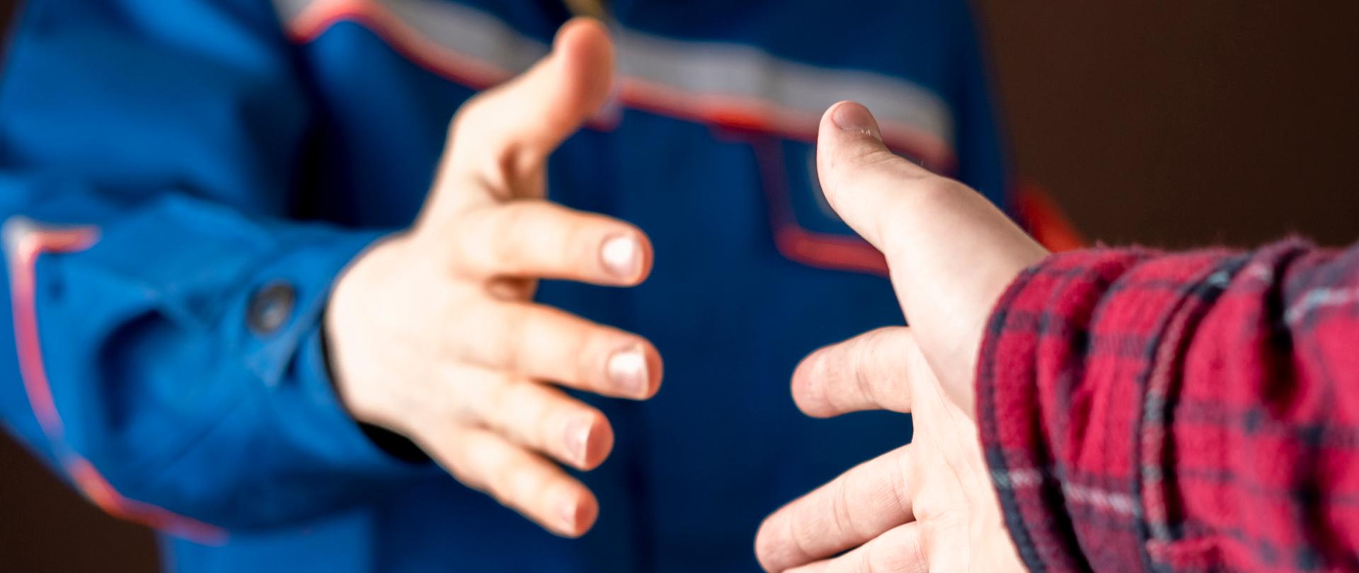 worker in blue uniform having a handshake with his customer