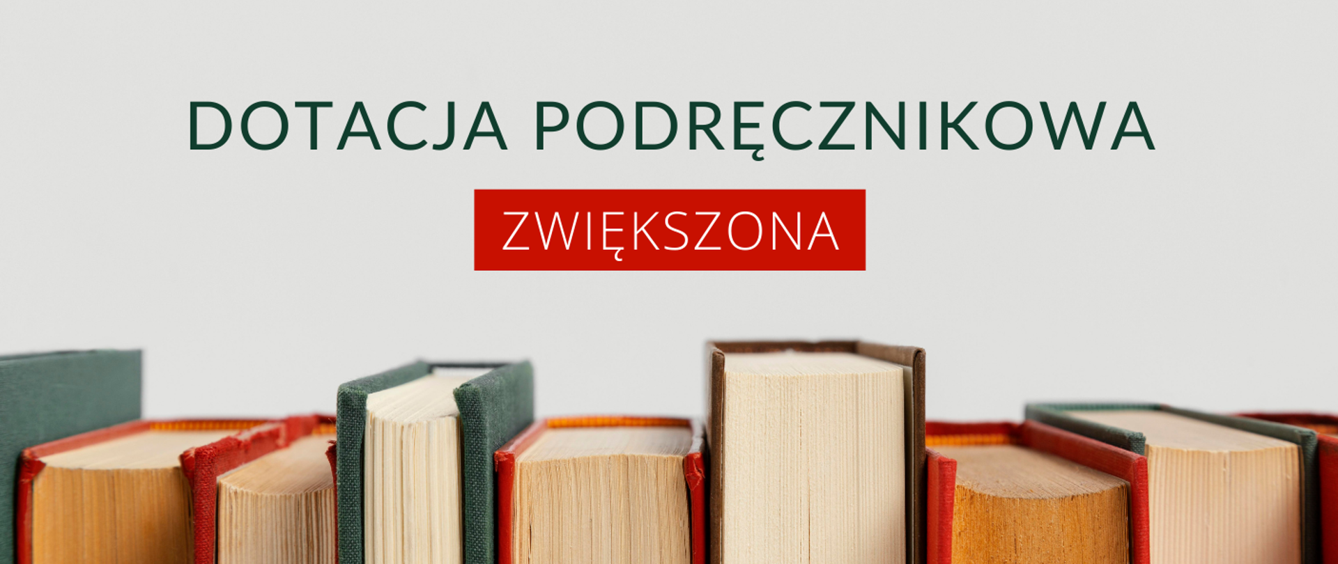Napis Dotacja podręcznikowa zwiększona poniżej ustawione w jednym rzędzie różnej wielkości książki 