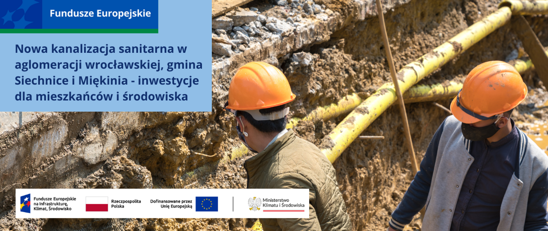Wykop, w środku dwóch mężczyzn, pracowników ubranych w kaski i maski.