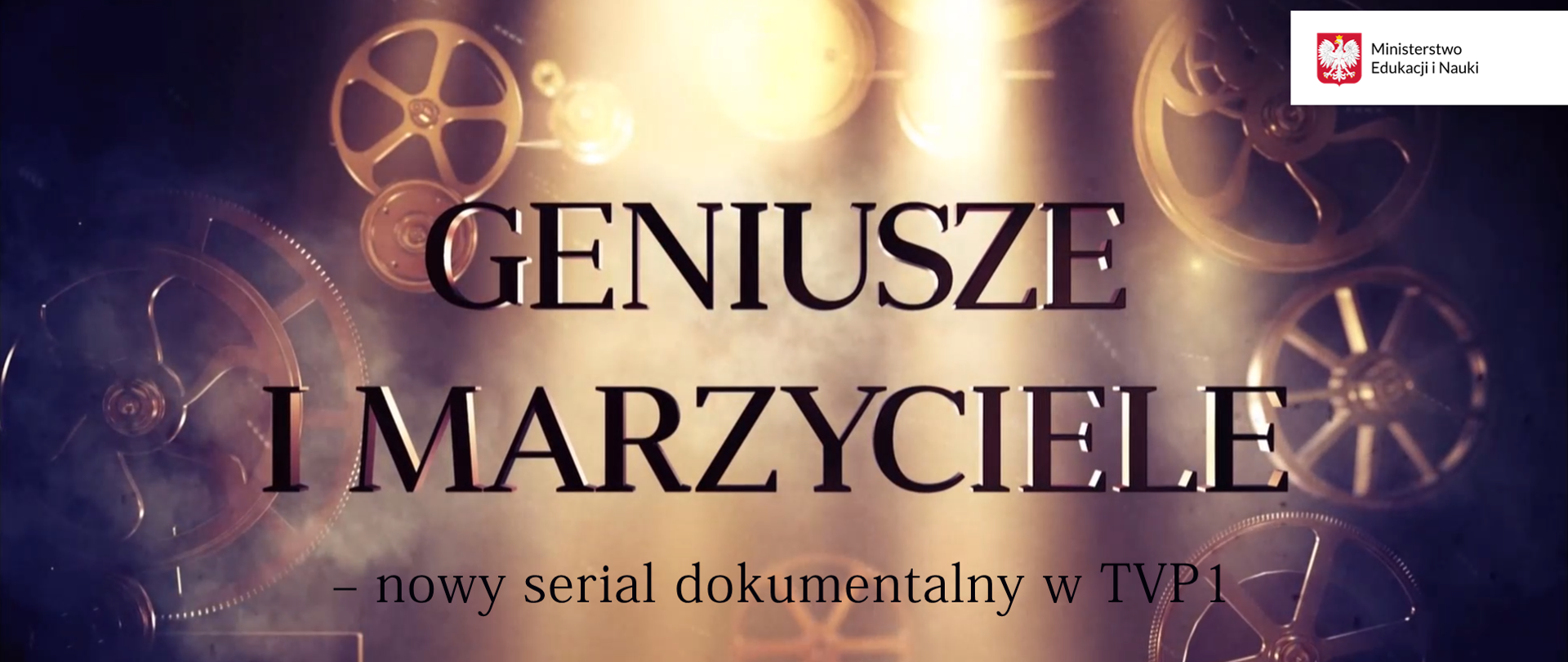 W tle obracające się kamery filmowe. Rozświetlony środek obrazka. Na środku napis Geniusze i marzyciele - nowy serial dokumentalny w TVP 1. Na górze po prawej stronie logotyp Ministerstwa Edukacji i Nauki. 