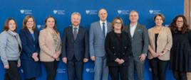 Wiceminister finansów Jurand Drop z biegłymi rewidentami i księgowymi pozują na ściance MF