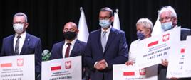 Premier z samorządowcami z czekami.
