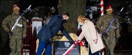 Premier odsłania tablicę.