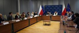 Minister funduszy i polityki regionalnej Katarzyna Pełczyńska-Nałęcz i wiceministra Monika Sikora z beneficjentami konkursu na inkubatory na innowacje społeczne, panie minister siedzą przy stołach z beneficjentami